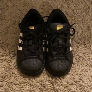 black Adidas Superstar shoes